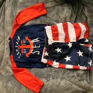 Red, white, and blue rashguard and swim trunks